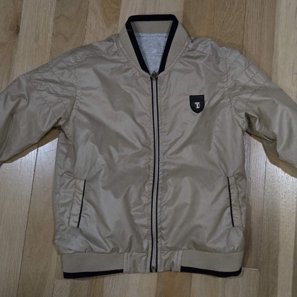 Tan Puffer Jacket with Black Trim and Lightweight Design